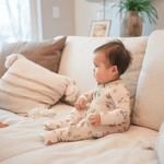 baby sittin gon couch wearing bamboo romper
