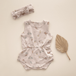 Flat lay of romper with matching headband.