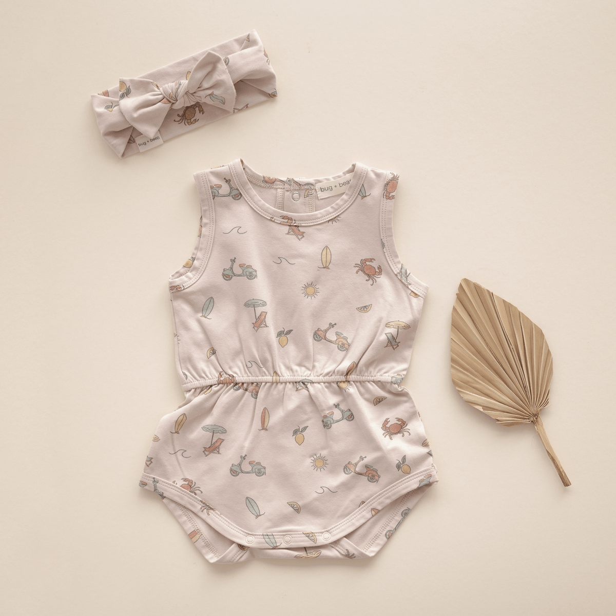 Flat lay of romper with matching headband.