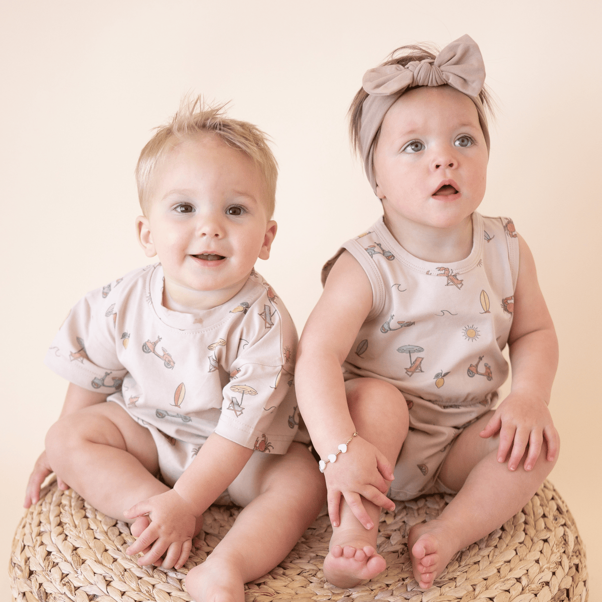 Two babies in matching Summer Vibes outfits